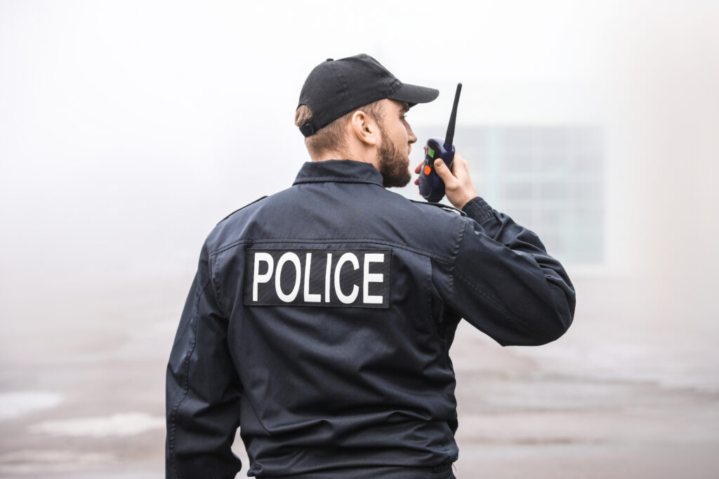 Male police officer patrolling city street